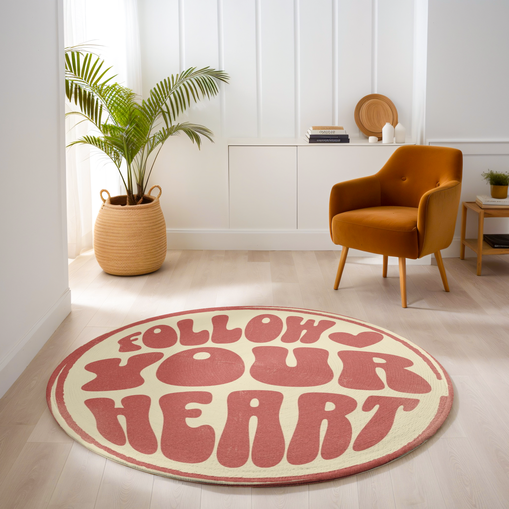 Round rug with retro pink text reading “Follow Your Heart” on a cream background, styled in a bright, modern room with playful decor.