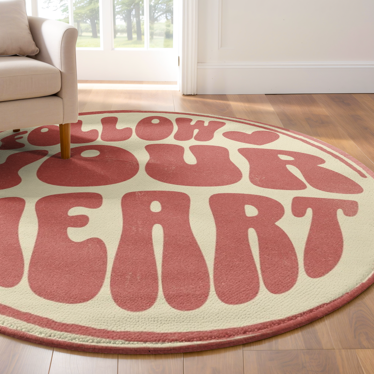 Round rug with retro pink text reading “Follow Your Heart” on a cream background, styled in a bright, modern room with playful decor.