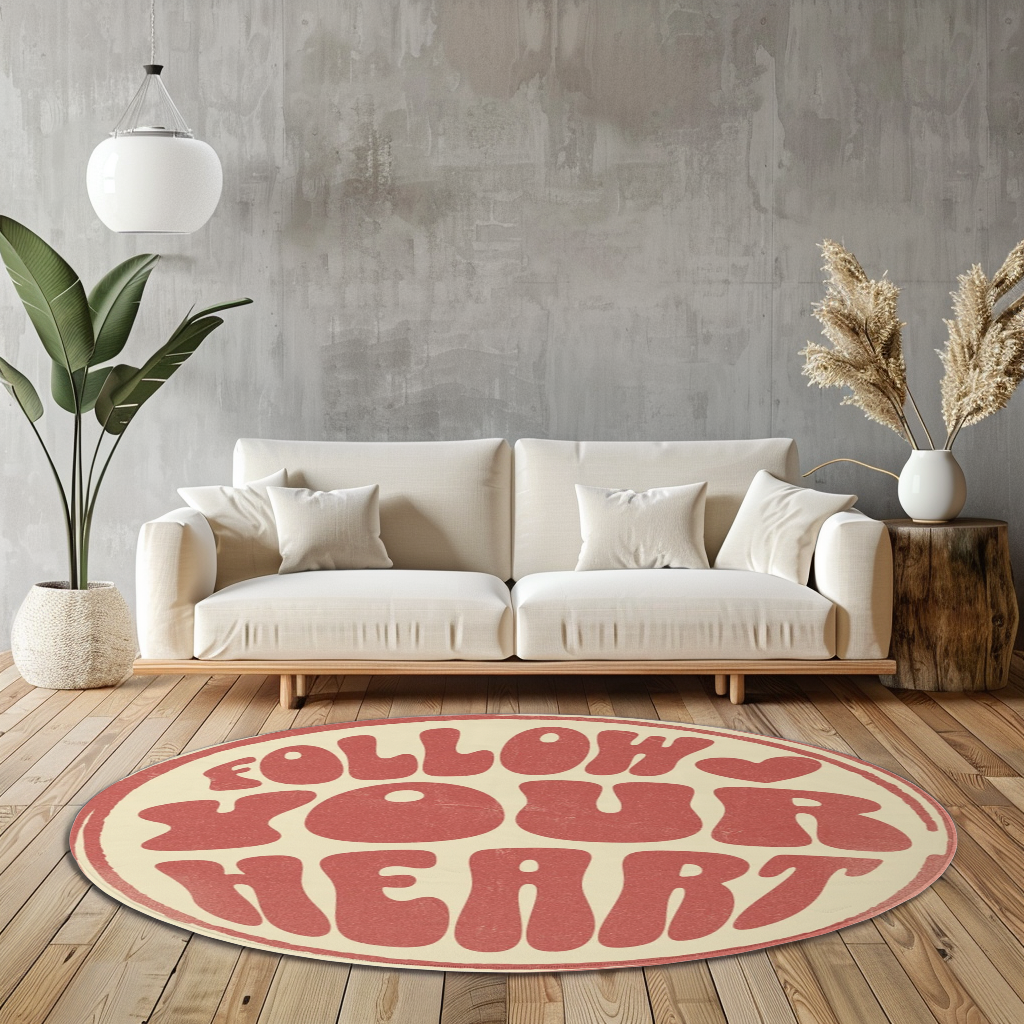 Round rug with retro pink text reading “Follow Your Heart” on a cream background, styled in a bright, modern room with playful decor.
