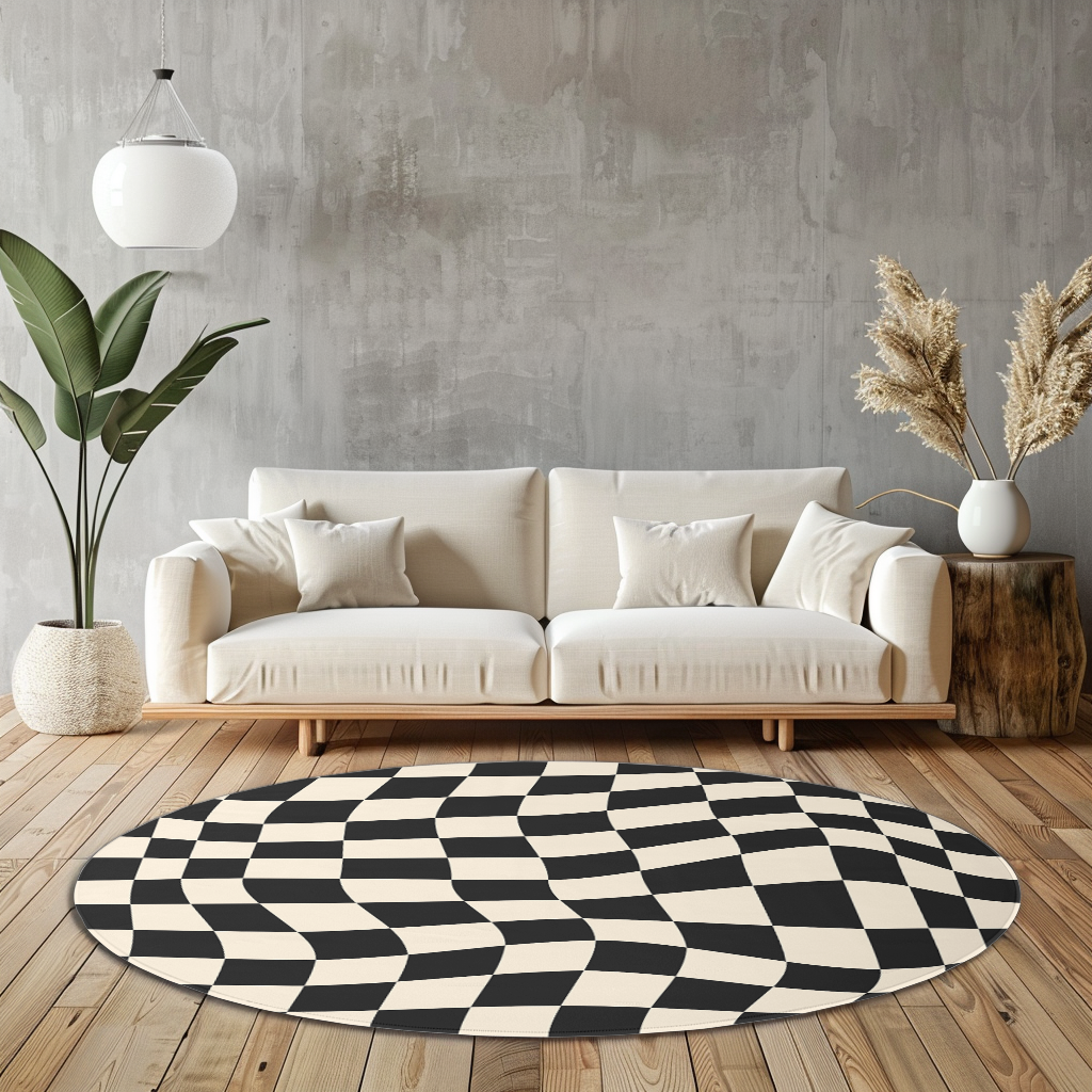 Round rug with black and white wavy checkerboard pattern, styled in a bright, modern room with wood flooring and minimal furnishings.