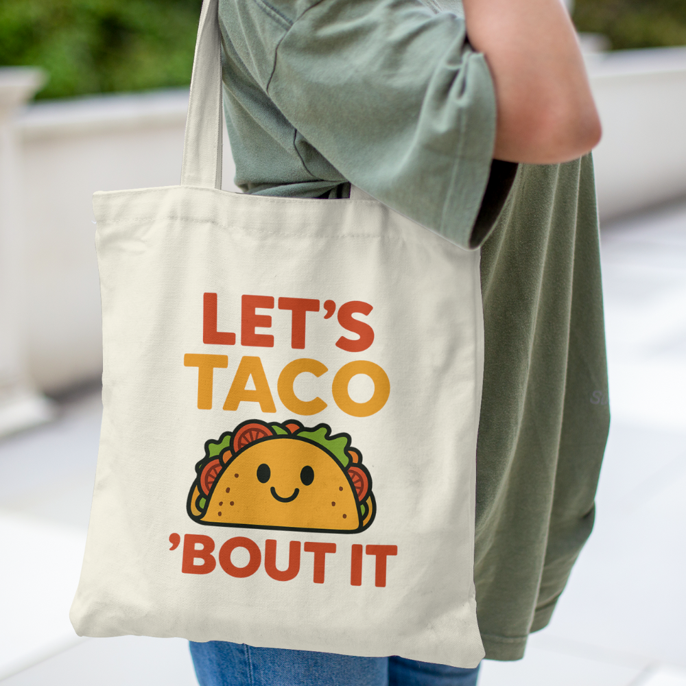 Tote bag with colourful quote “Let’s Taco ’Bout It” and cute smiling taco graphic