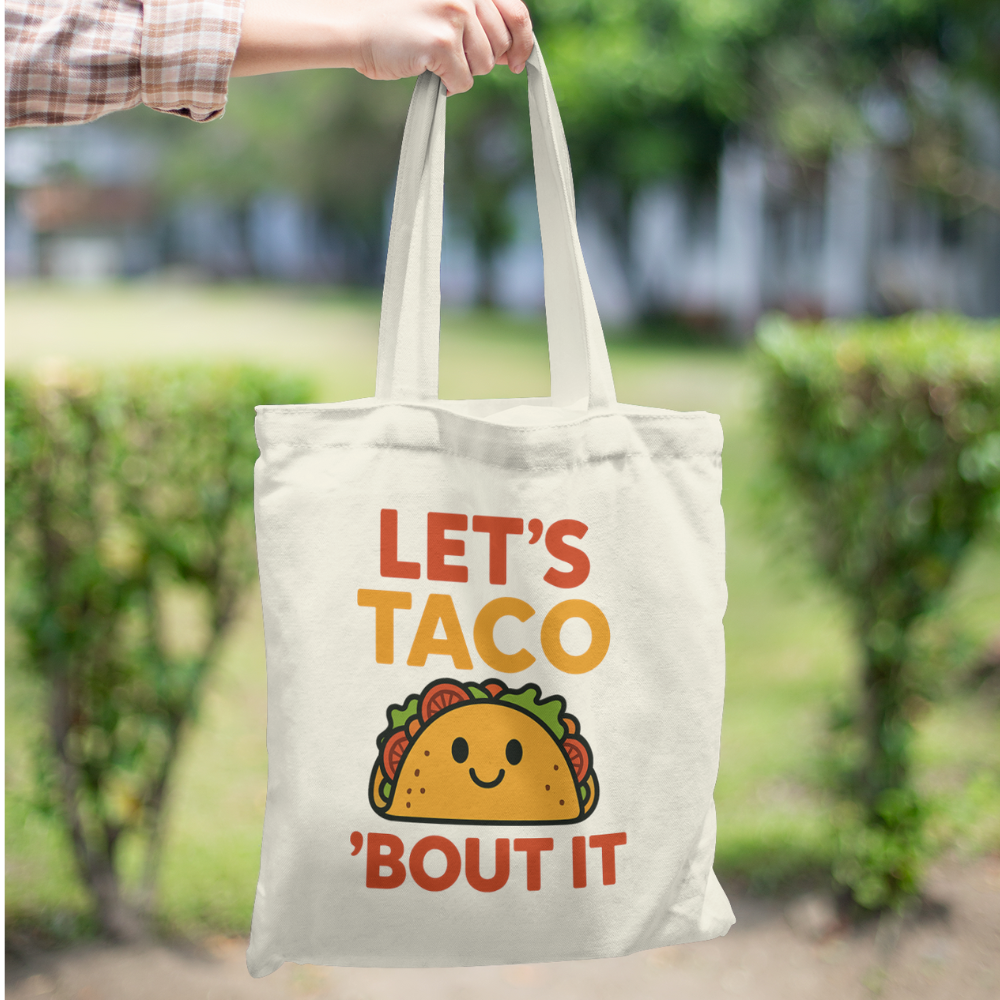 Tote bag with colourful quote “Let’s Taco ’Bout It” and cute smiling taco graphic