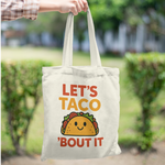 Tote bag with colourful quote “Let’s Taco ’Bout It” and cute smiling taco graphic