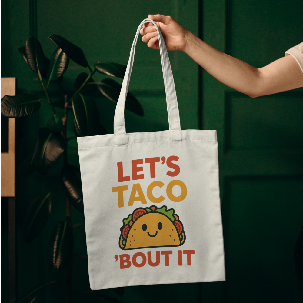 Tote bag with colourful quote “Let’s Taco ’Bout It” and cute smiling taco graphic