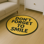 Round yellow rug with motivational quote ‘Don’t Forget to Smile’ in bold black letters, placed on a light wooden floor.