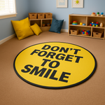 Round yellow rug with motivational quote ‘Don’t Forget to Smile’ in bold black letters, placed on a light wooden floor.