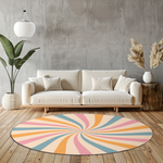 Round rug with pastel swirl design in blush pink, soft blue, golden yellow and ivory, styled in a clean, modern interior.