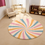 Round rug with pastel swirl design in blush pink, soft blue, golden yellow and ivory, styled in a clean, modern interior.