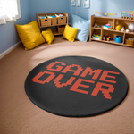 Round black rug with red pixel-style “GAME OVER” text, placed in a bright modern room with minimalist furnishings and warm neutral tones.