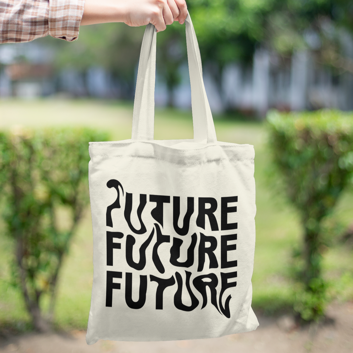 Tote bag with warped black text repeating “FUTURE FUTURE FUTURE” – modern cotton canvas bag held on shoulder, minimalist design