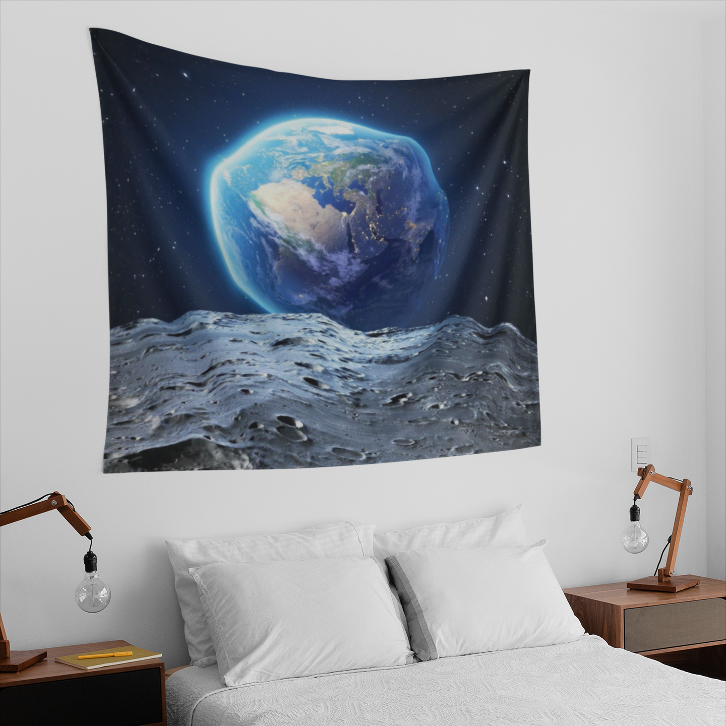 A tapestry image showing planet Earth rising above the moon’s surface, with detailed craters in the foreground and a star-filled galaxy in the background.