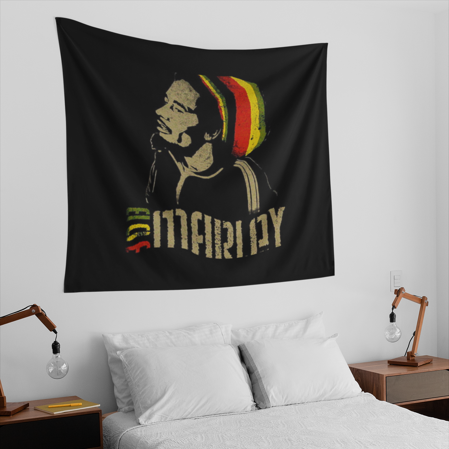 Black tapestry featuring a stencil-style portrait of Bob Marley in profile wearing a red, yellow, and green Rasta beanie, with the text "Bob Marley" below in distressed beige lettering, and "Bob" colored in green, yellow, and red.